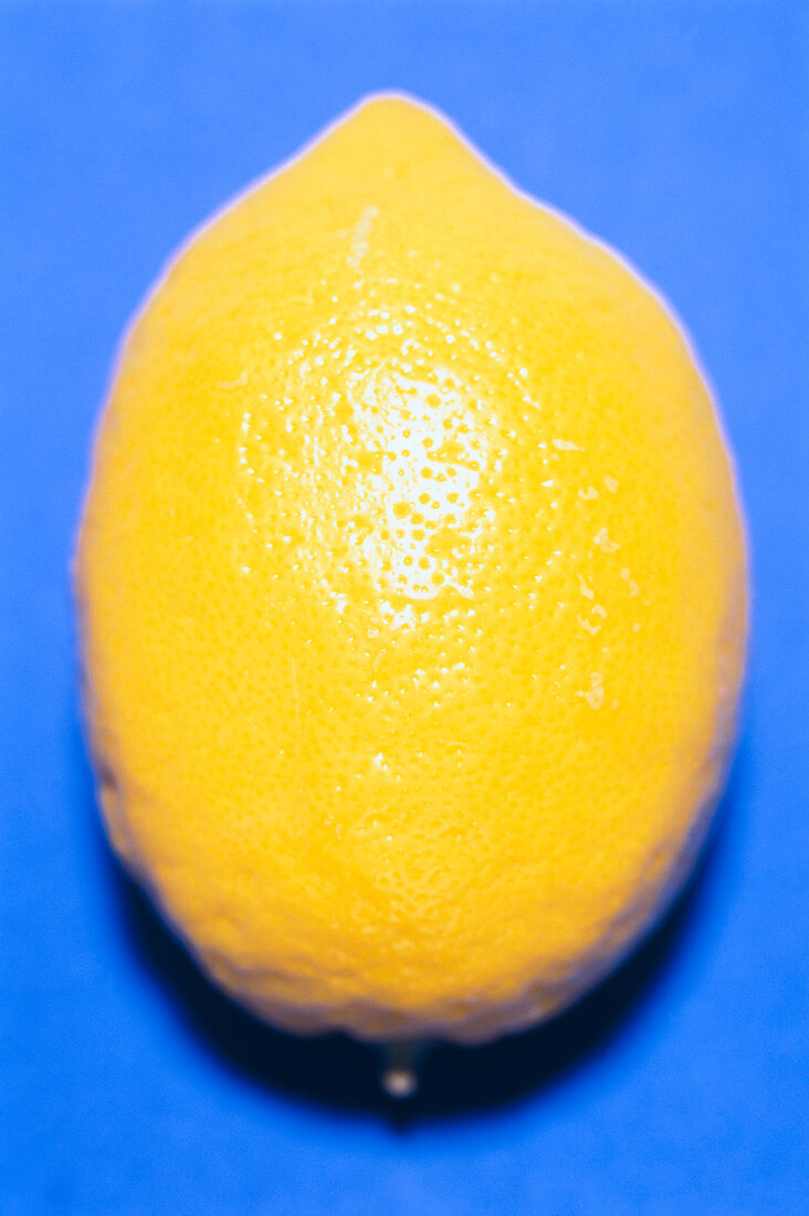 Close-up of lemon on blue background