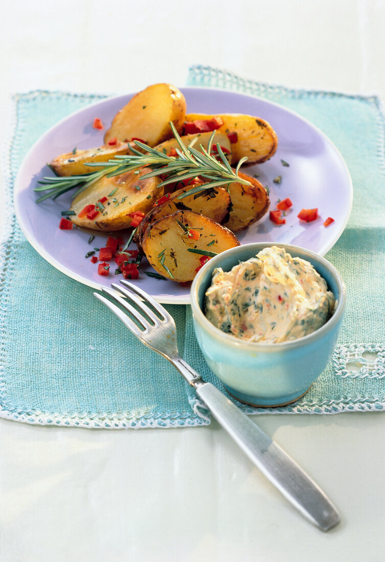 Vegetarian rosemary potatoes on plate with pepper dip
