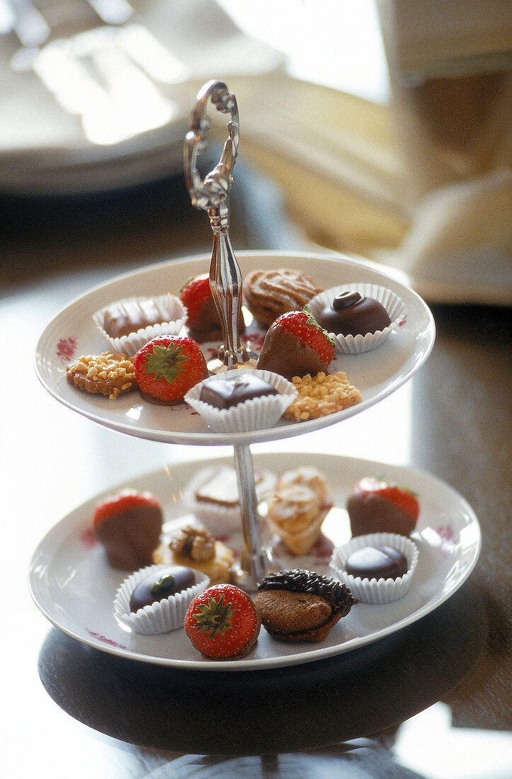 Different chocolate sweets on cake stand
