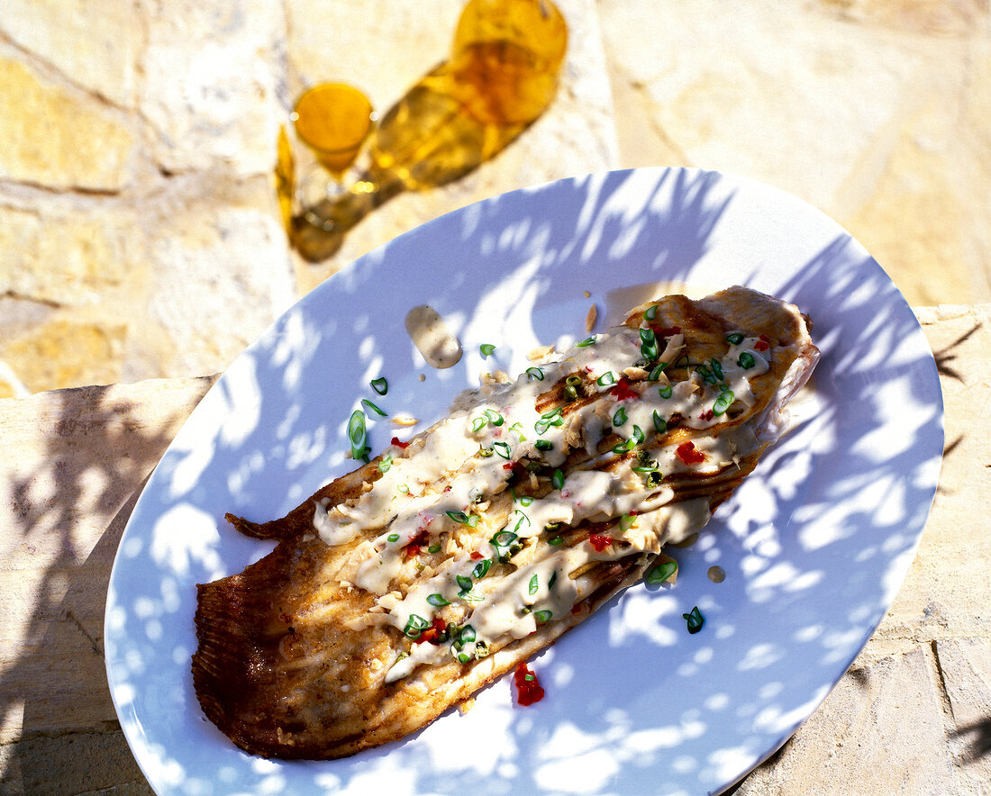 Skate wing with tuna mayonnaise on plate