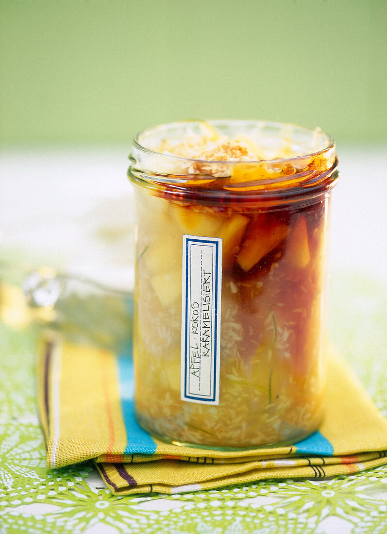 Homemade caramelized apple and coconut jam in jar