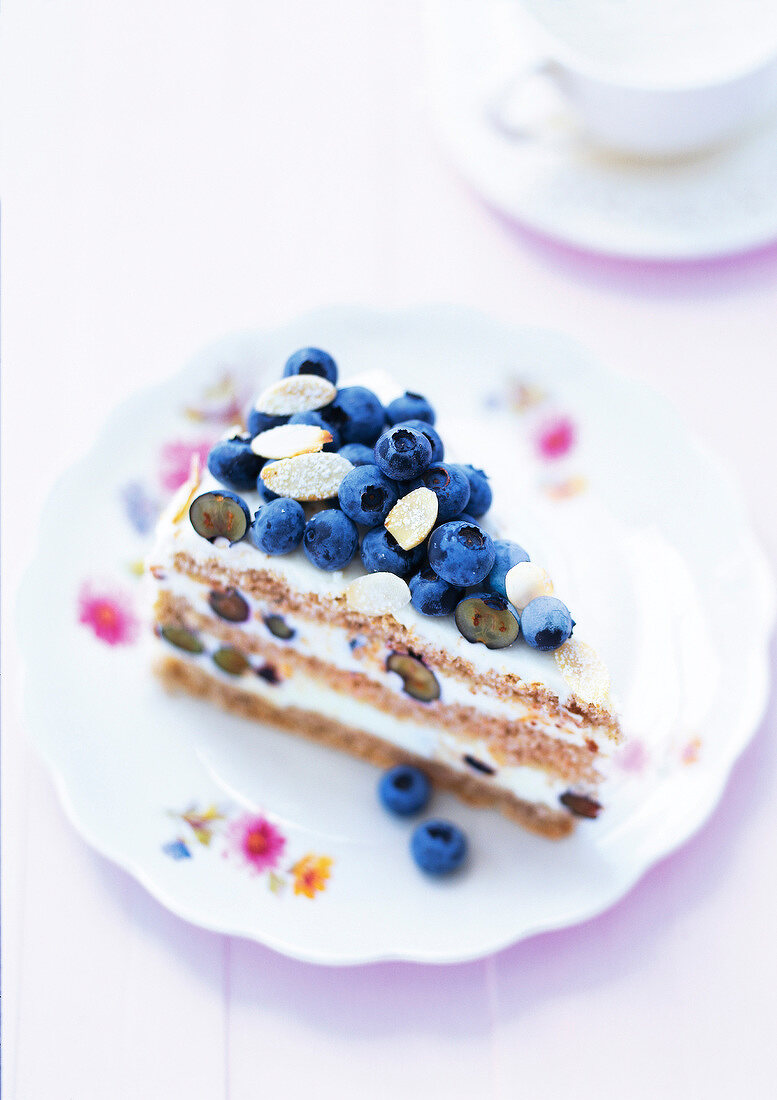 Buckwheat cake with blueberries and almonds on plate