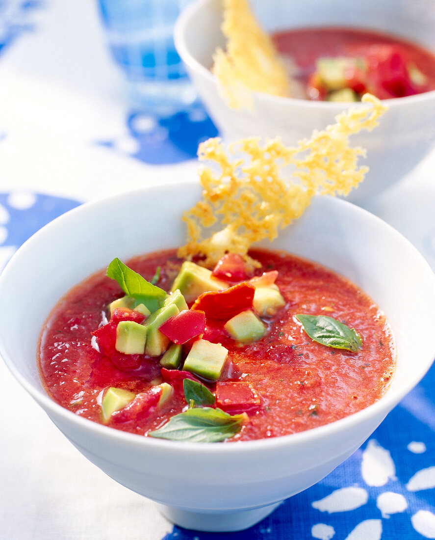 Gazpacho with avocado and parmesan cheese in bowl