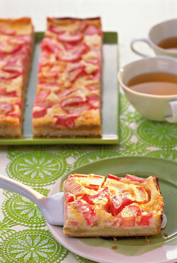 Piece of rhubarb cake with marzipan on plate
