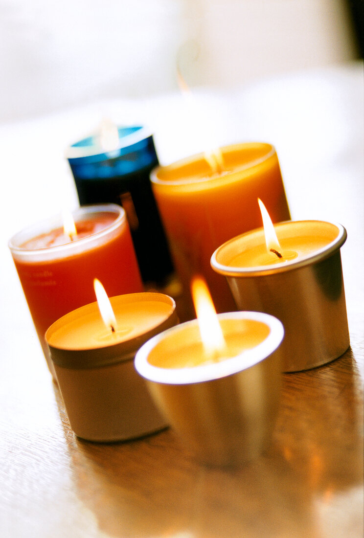 Close-up of multi-coloured burning scented candles