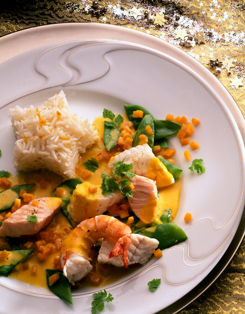 Close-up of fish stew with salmon fillet, zander and shrimp served on plate