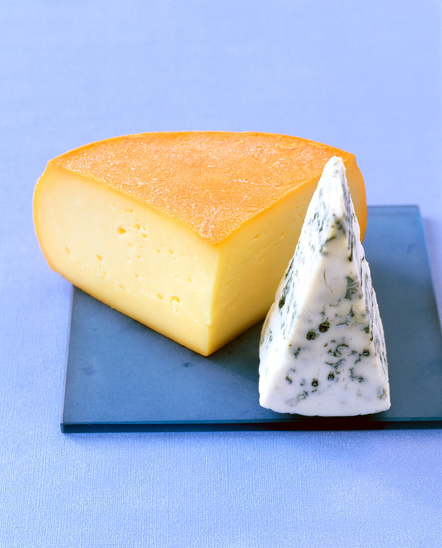 Close-up of semi-soft cheese on blue veined stone