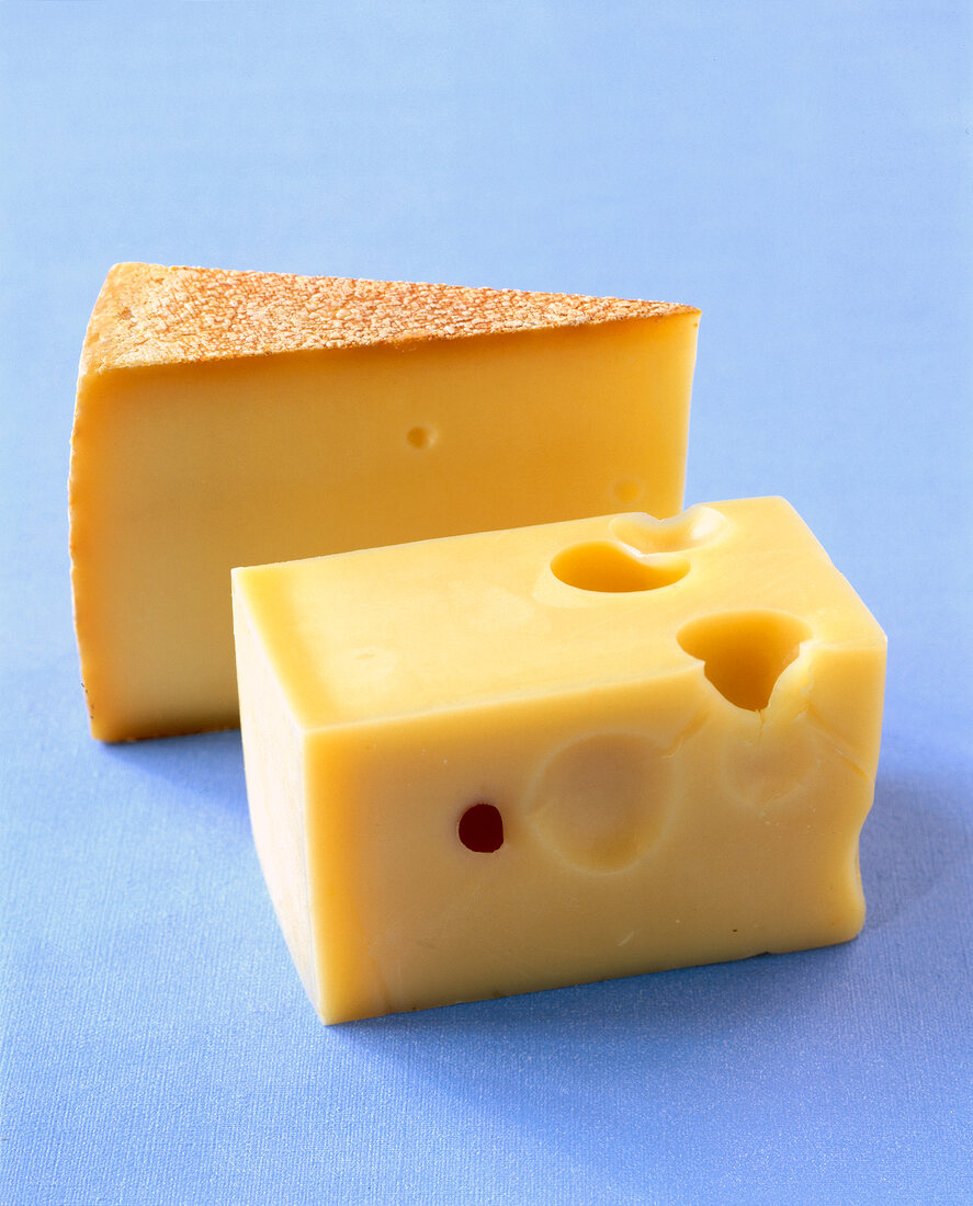 Close-up of harzer cheese and basket cheese on blue background