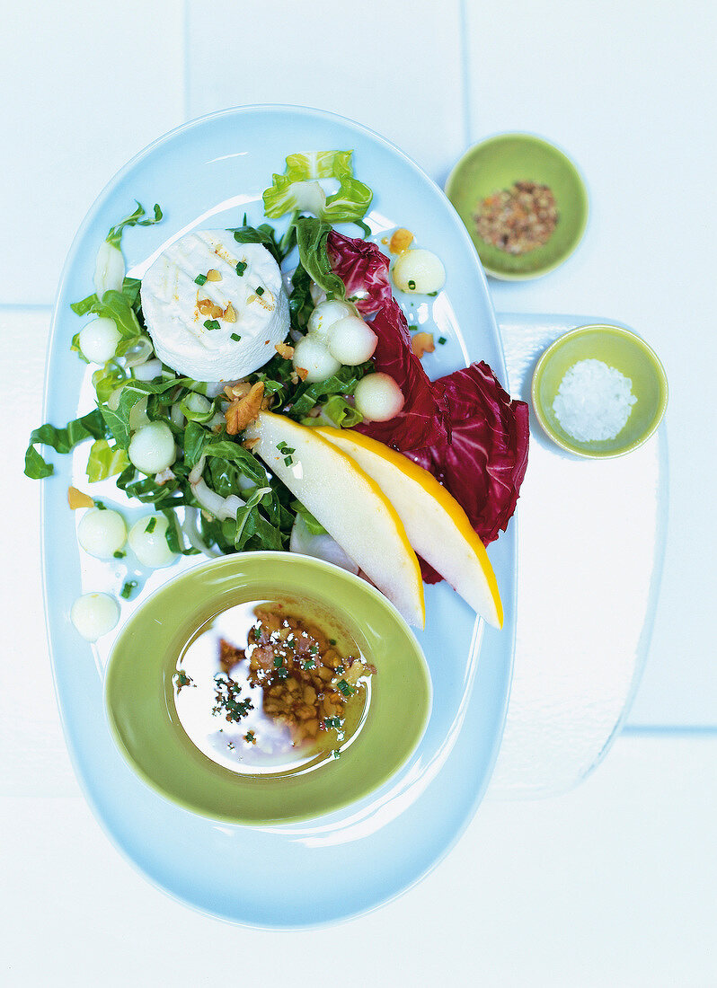 Chard and melon salad with goat cheese on serving dish for weight loss