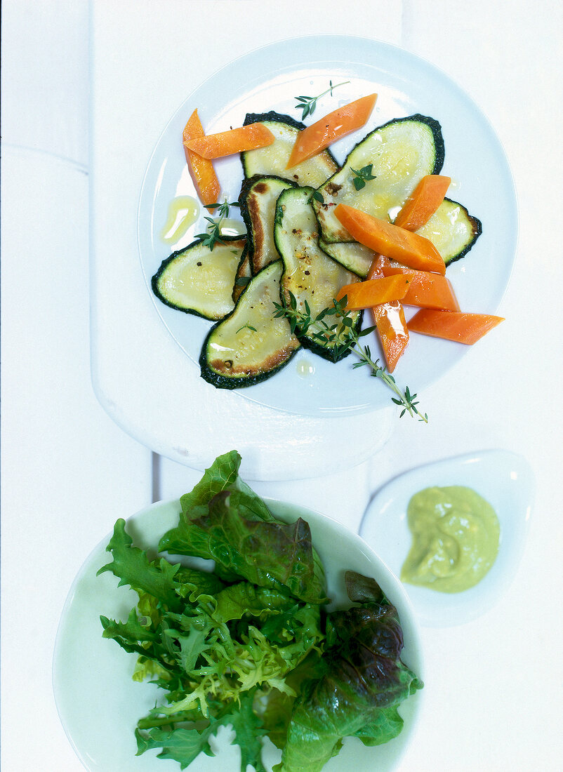 Marinated vegetables with lettuce carrots, zucchini and lettuce on plate