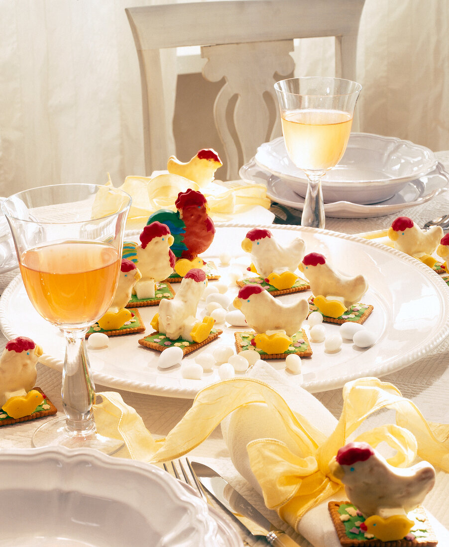 Rooster and hen shaped pastry on laid table