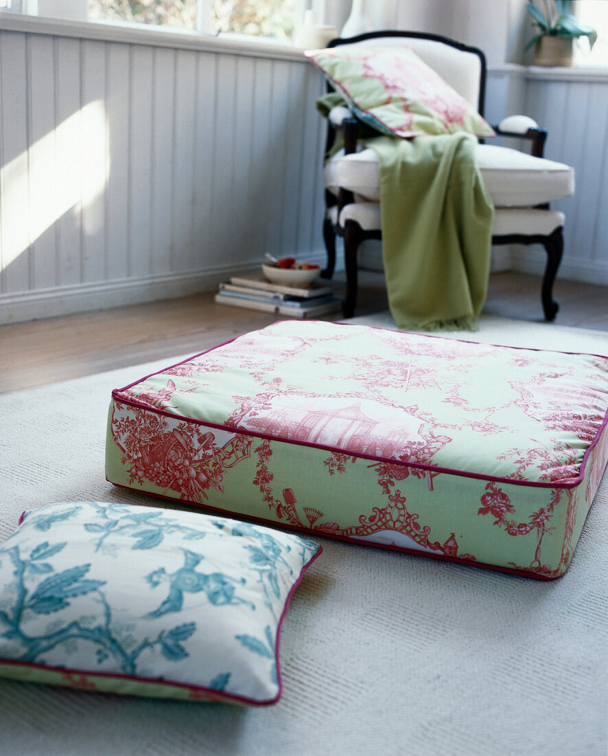 Cushions with Toile de Jouy pattern on floor