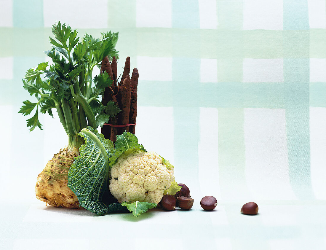 Celeriac, cauliflower and chestnuts on white background