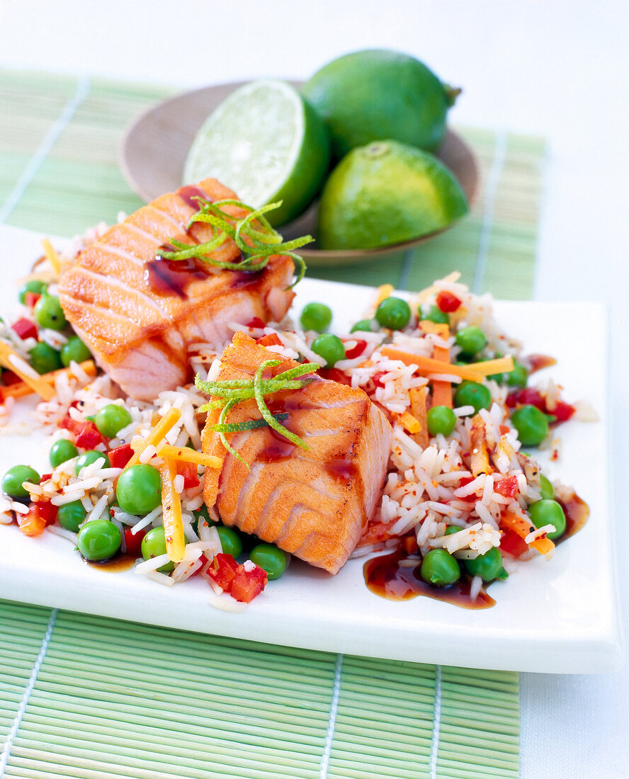 Teriyaki salmon with green peas and rice on plate