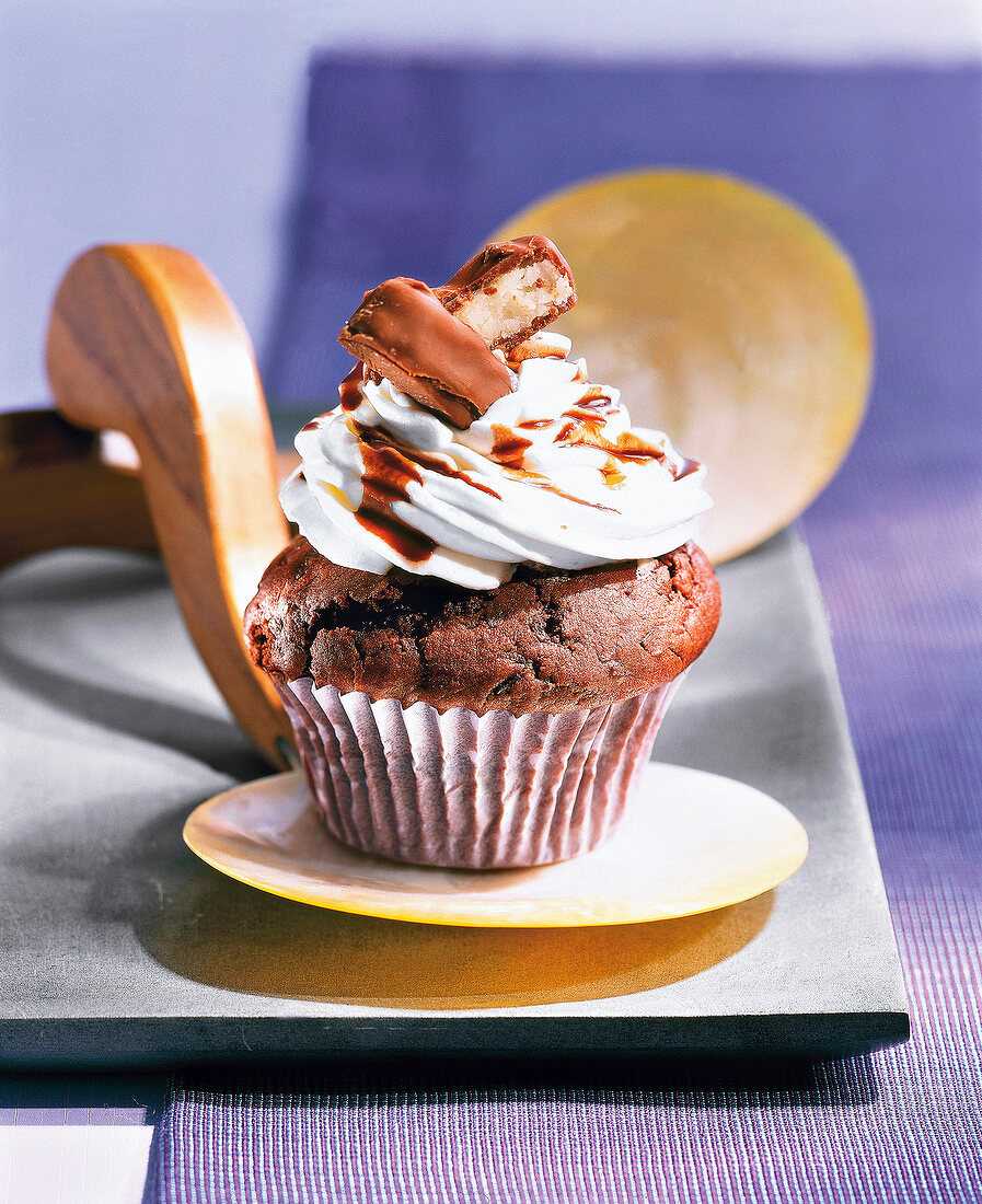 Bounty muffin with icing on small serving dish