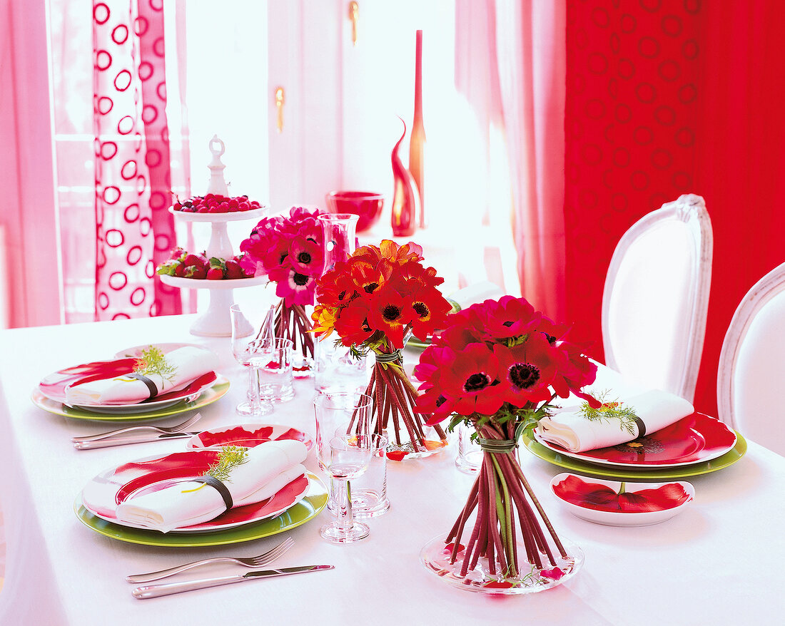 Dining table decorated with red flowers