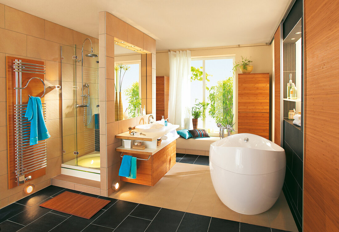 Interiors of wooden bathroom with bathtub and shower stall