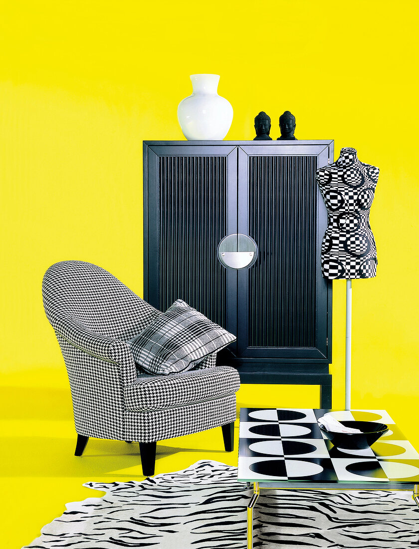 Chair, carpet, cupboard and mannequin couture in black and white on yellow background