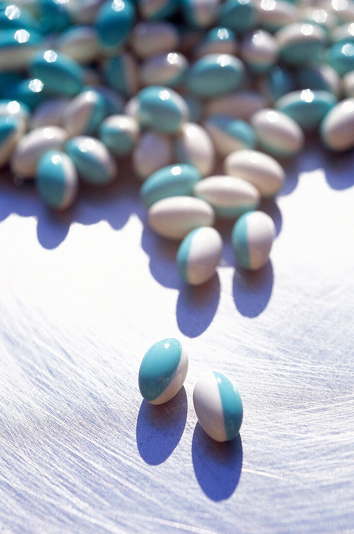 Close-up of several blue and white tablets on bright background