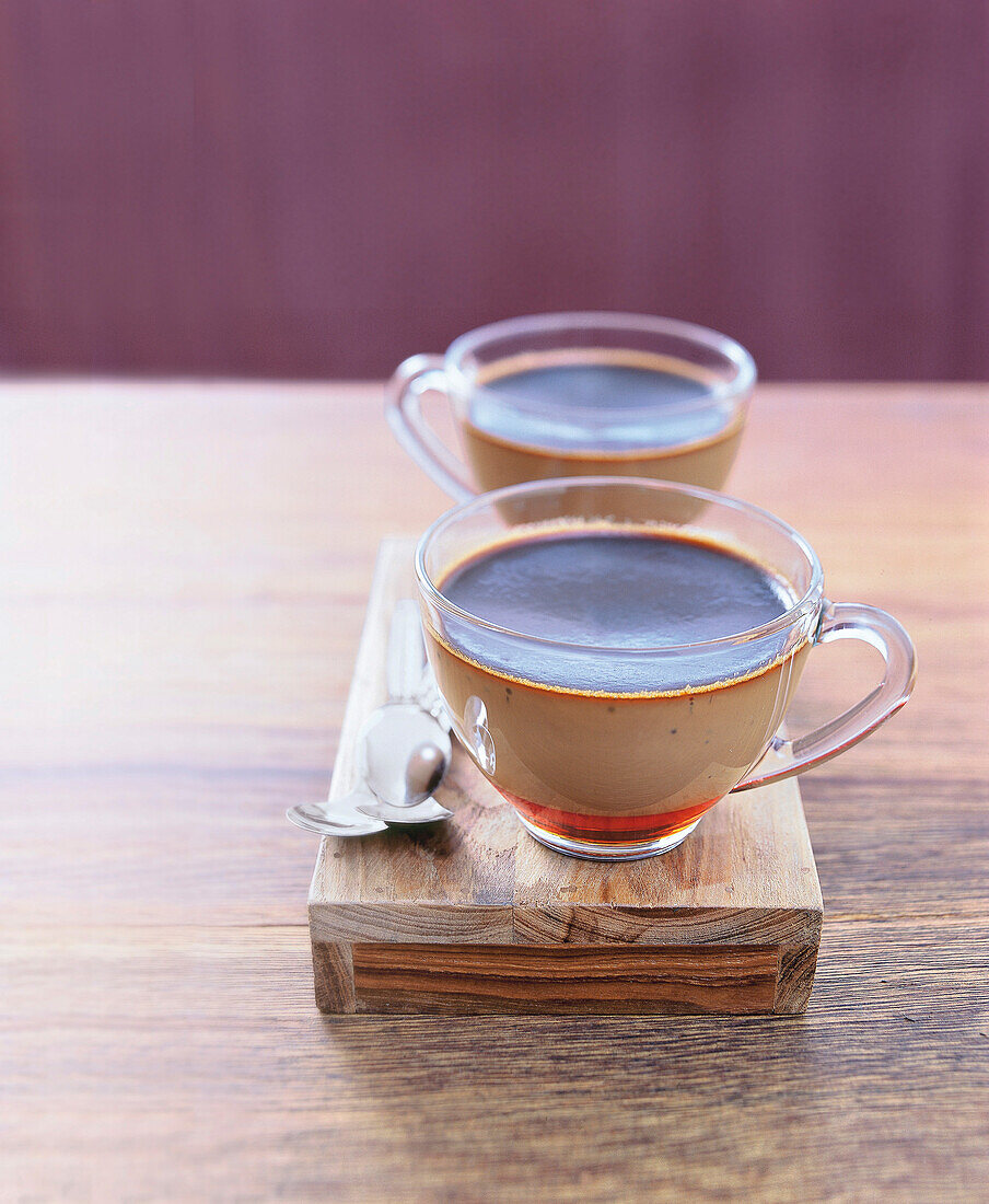 Cup of coffee creme caramel on wooden board