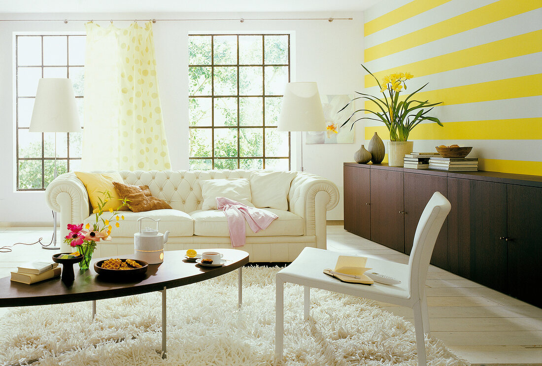 View of bright living room with big white sofa