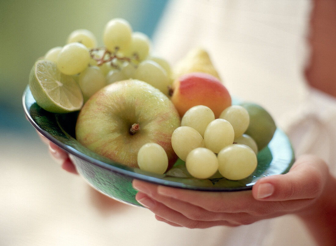 Close-up of variety of fruits in green bowl