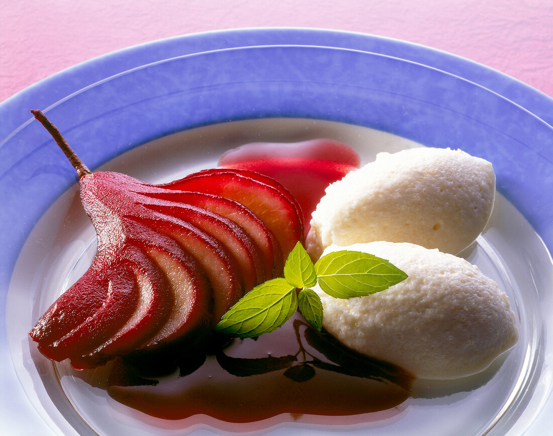 Close-up of elderberry pear with cream on plate