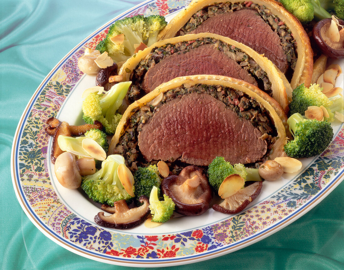 Beef fillet in puff pastry with mushroom stuffing on serving dish