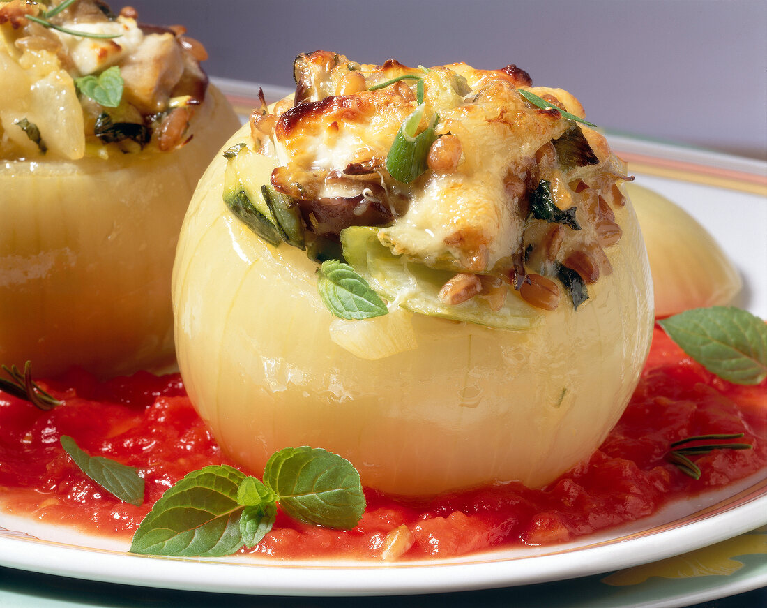 Close-up of stuffed onions with eggplant zucchini and feta cheese on plate