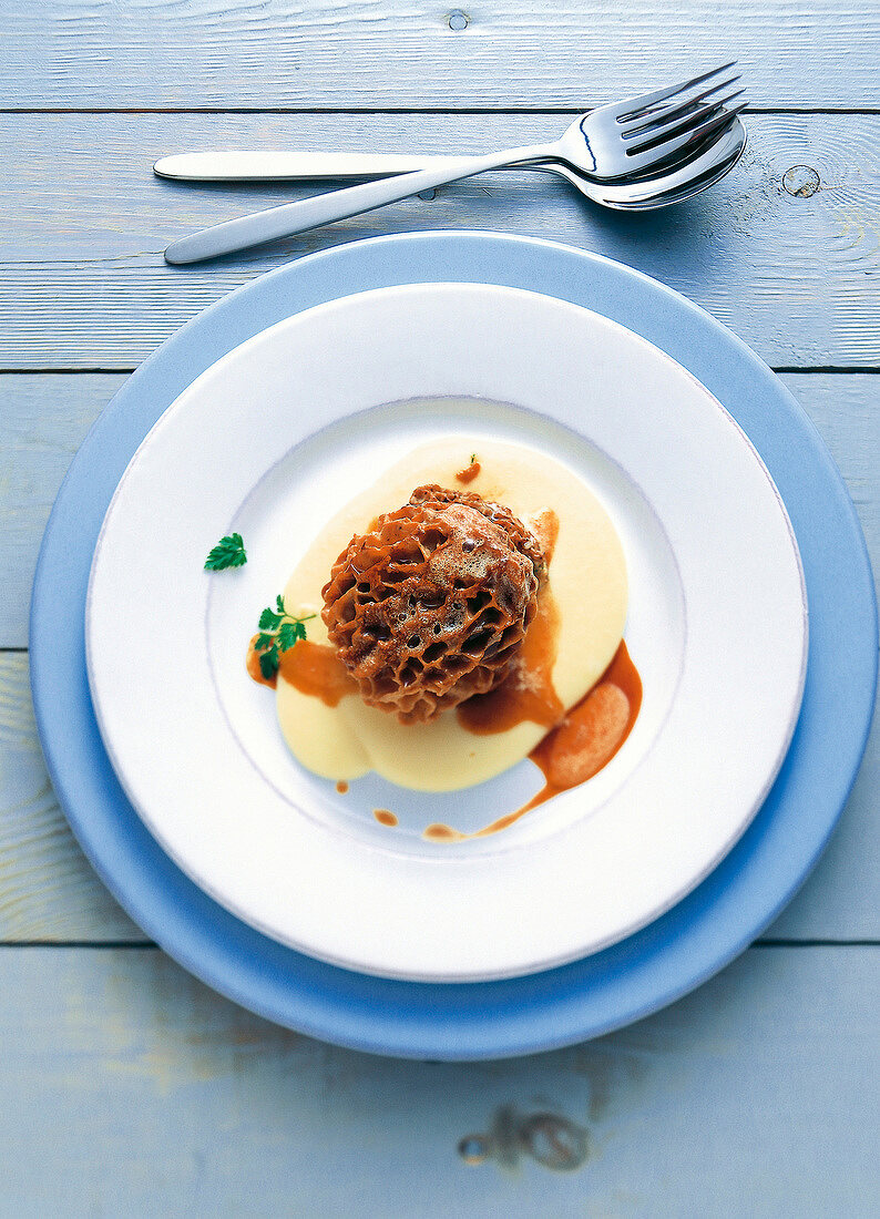Close-up of stuffed morels with mashed potatoes and brown butter on plate