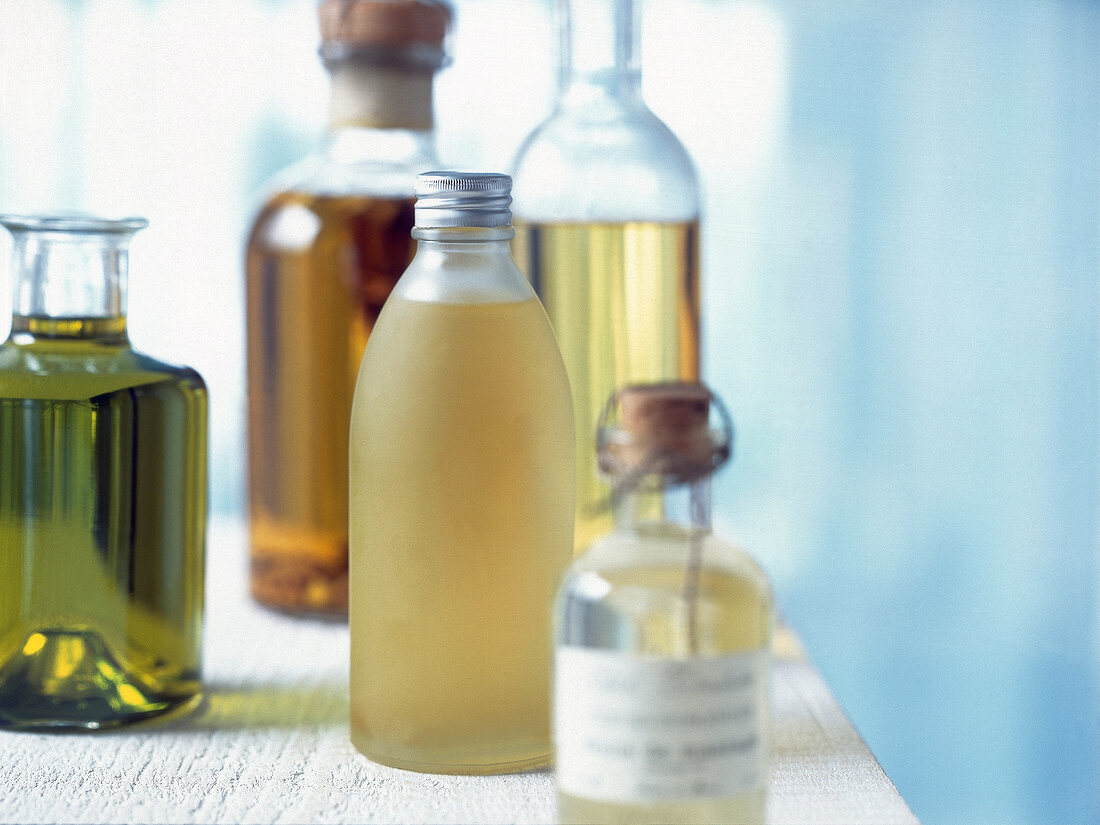 Close-up of different oils in different bottles on table