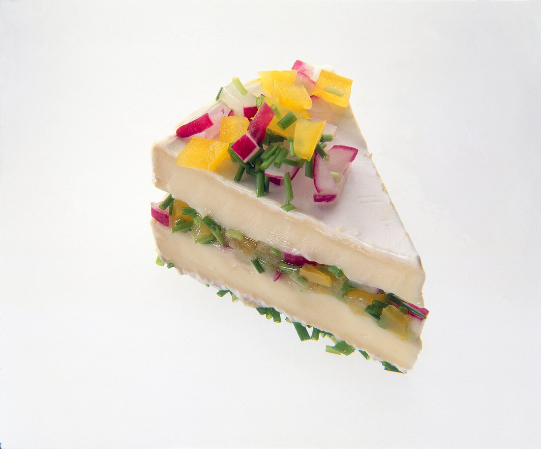 Appetizer with peppers, radishes and chives between two pieces of piece Paglietta cheese