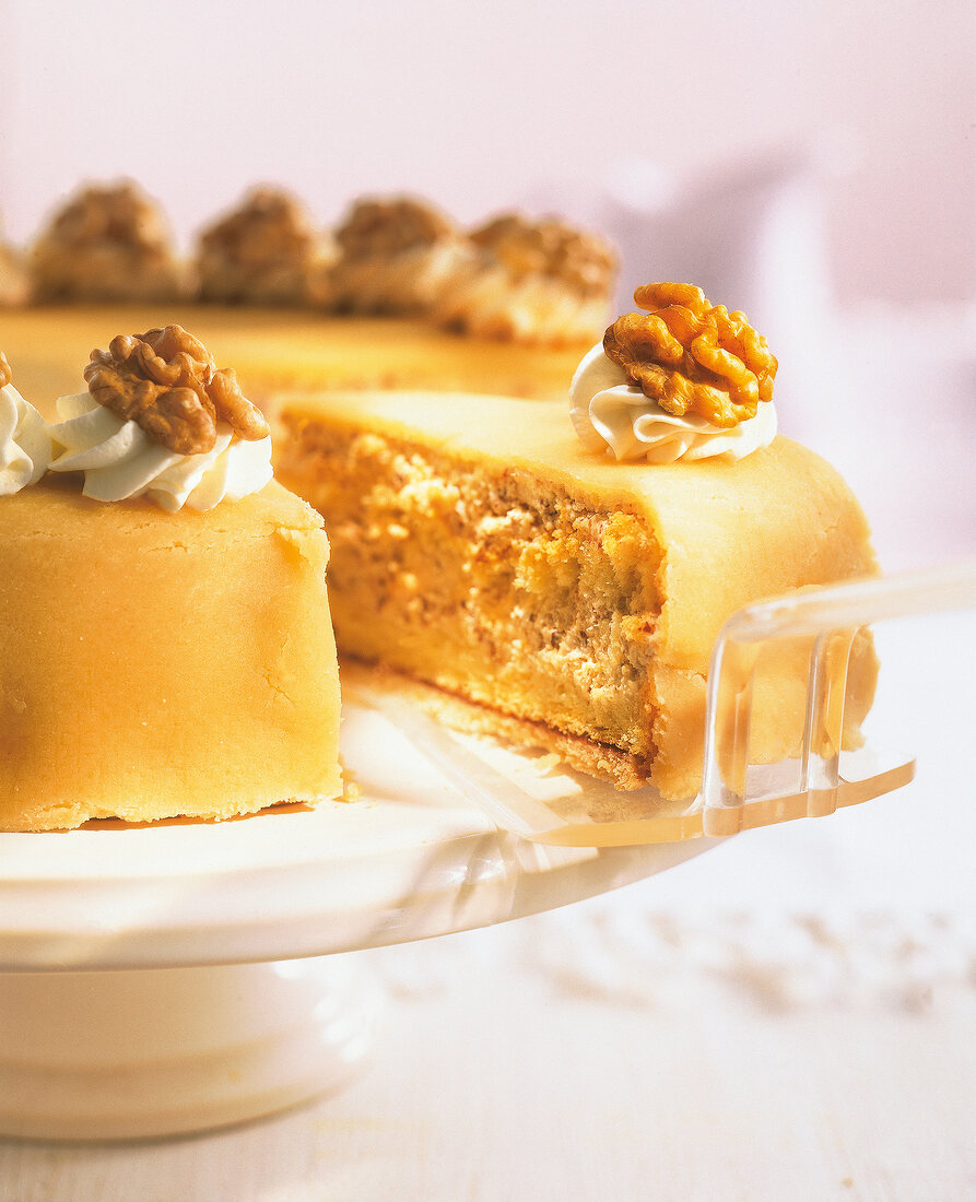Close-up of marzipan nut cake with cake server on a cake stand
