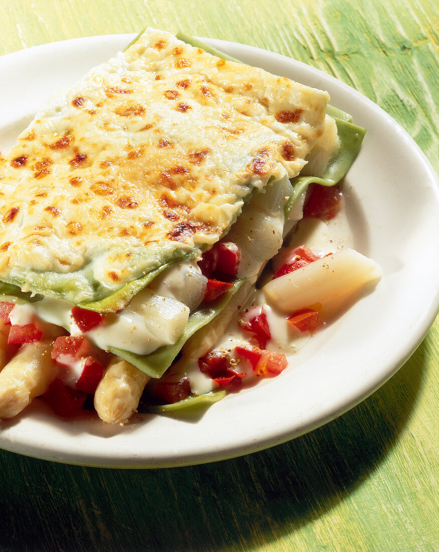 Close-up of lasagne with asparagus and gorgonzola sauce on plate