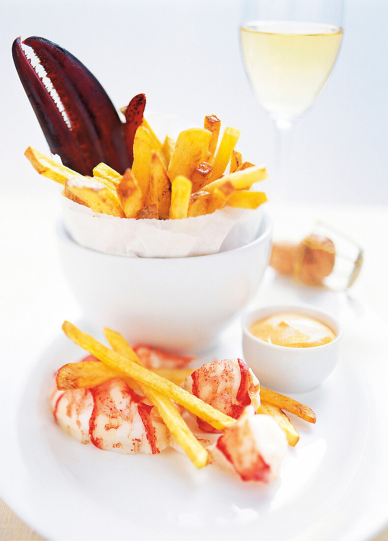 Lobster and French fries on plate with mayonnaise dip in bowl