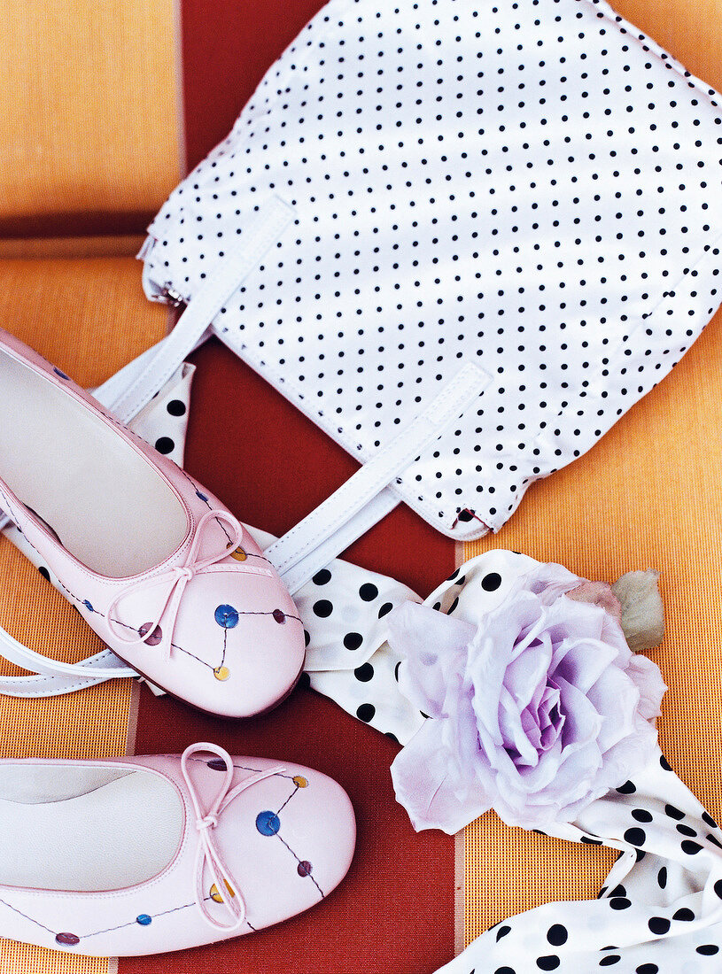 White purse, pink shoes and scarf in 50's style on striped background