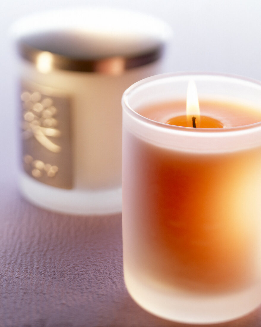 Close-up of burning scented candle in glass