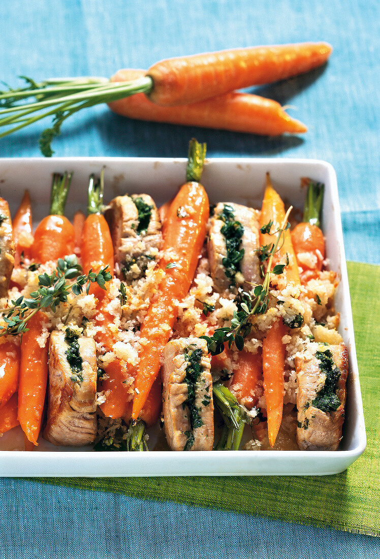 Carrots with parmesan crust and pork in baking tray
