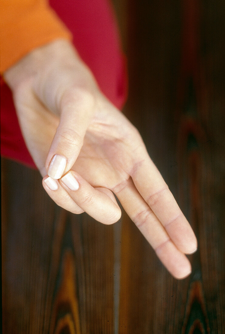 Close-up of hand mudra being performed for exercising finger, overhead view