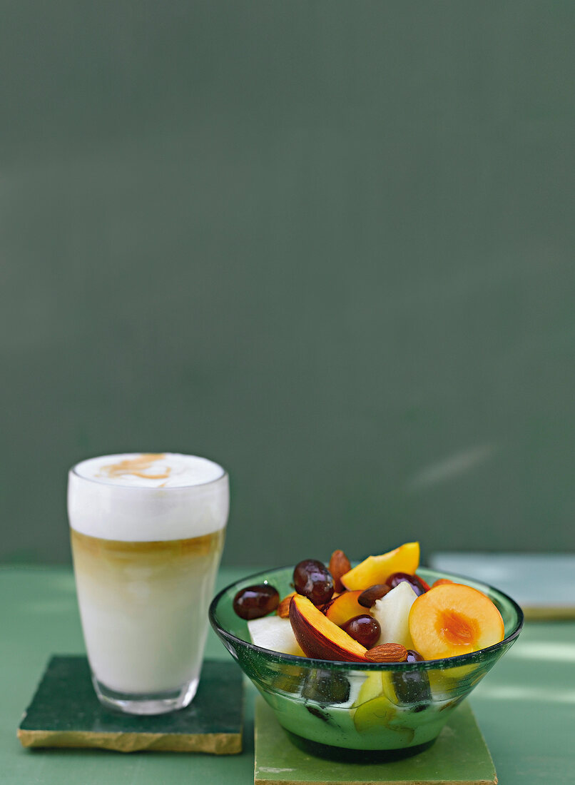 Breakfast with Cafe Latte and fresh fruits in bowl