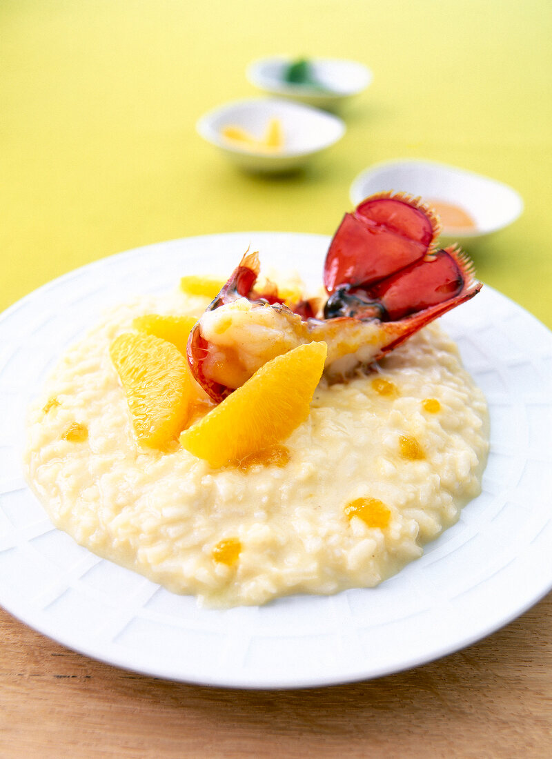 Risotto with orange mustard and lobster on plate