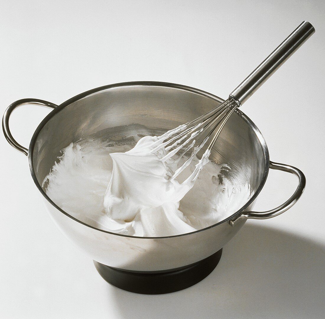 Whipped Egg Whites in Mixing Bowl; Whisk