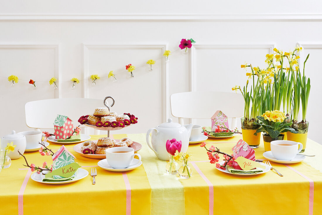 A festively laid table laid for Easter with cakes and tea
