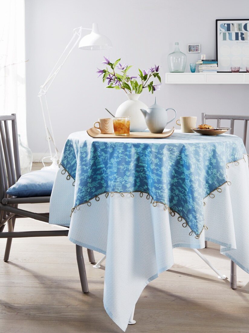 A homemade, two-in-one tablecloth on a round dining table