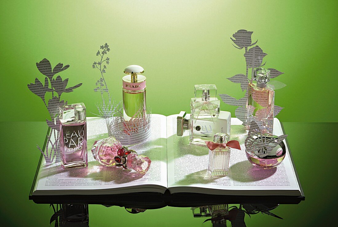 Various perfume bottles against a green background