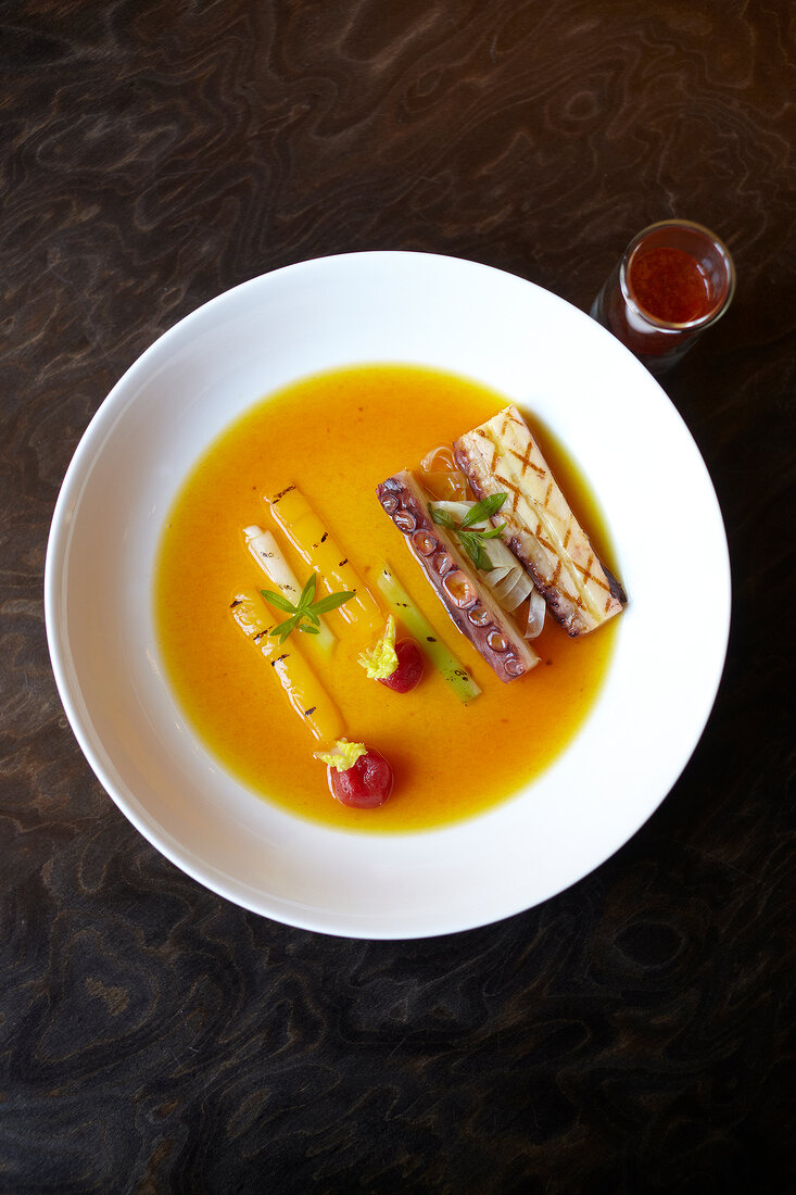 Tomato broth with saffron and grilled octopus