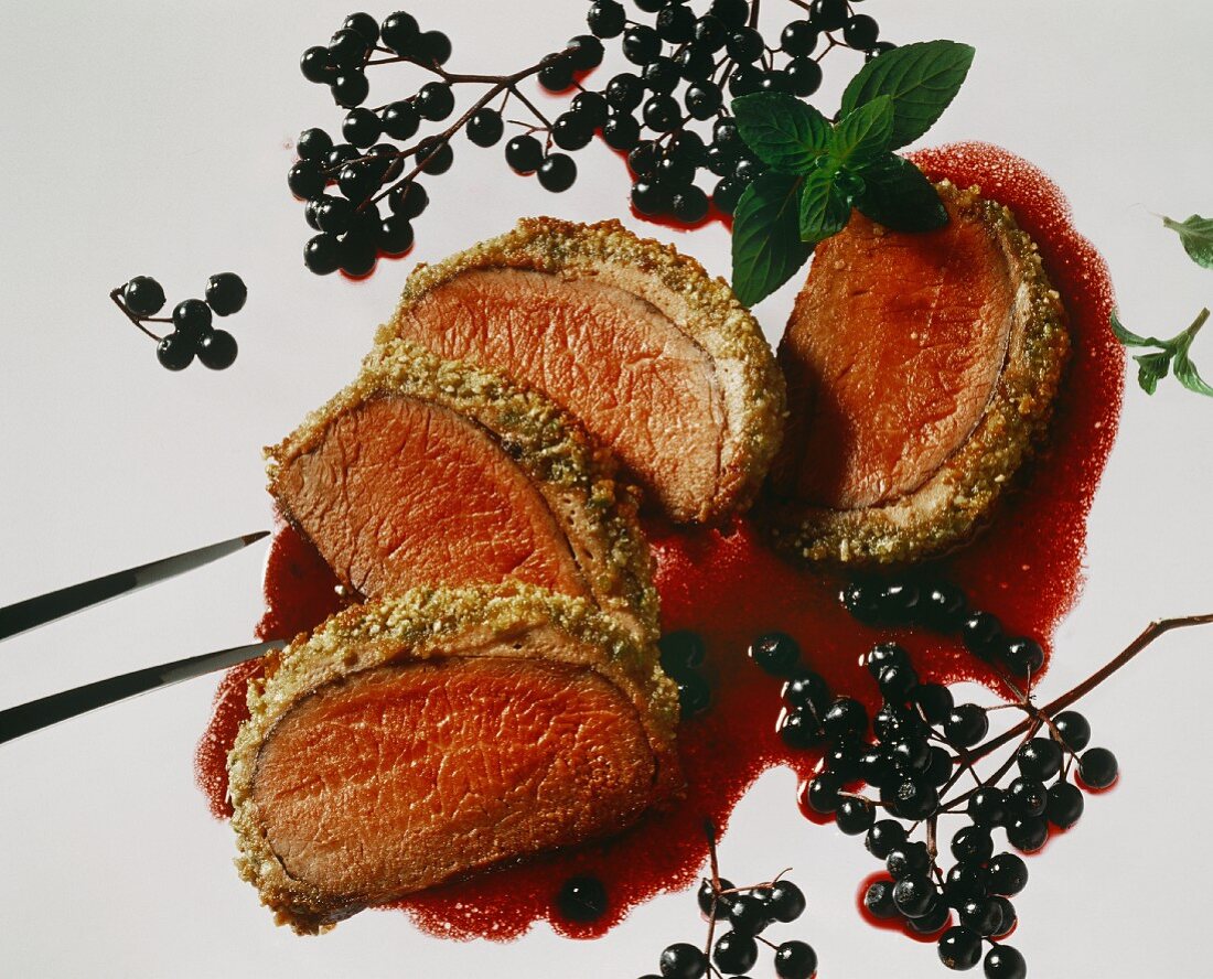 Saddle of venison in a nut crust with elder sauce