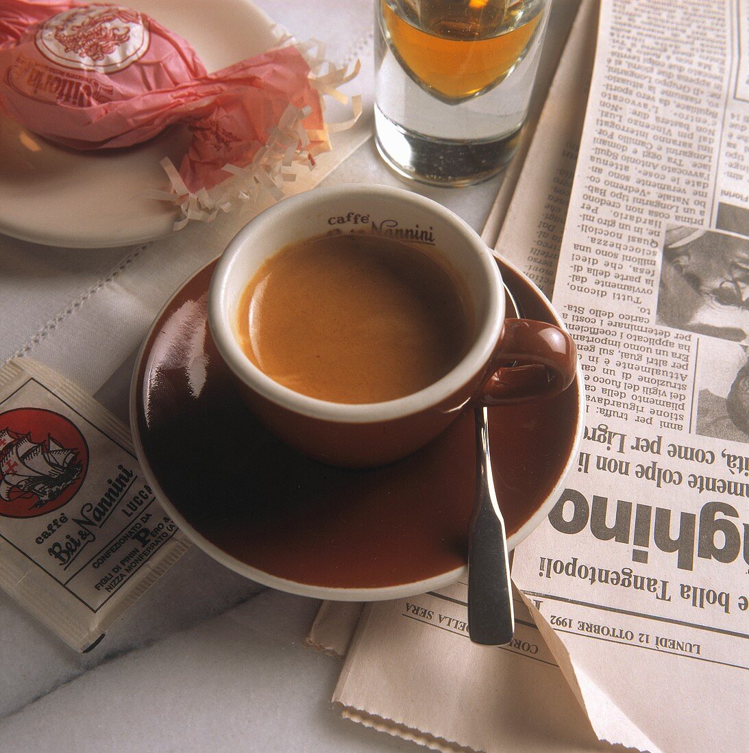 Cup of Espresso in Brown Cup; Newspaper