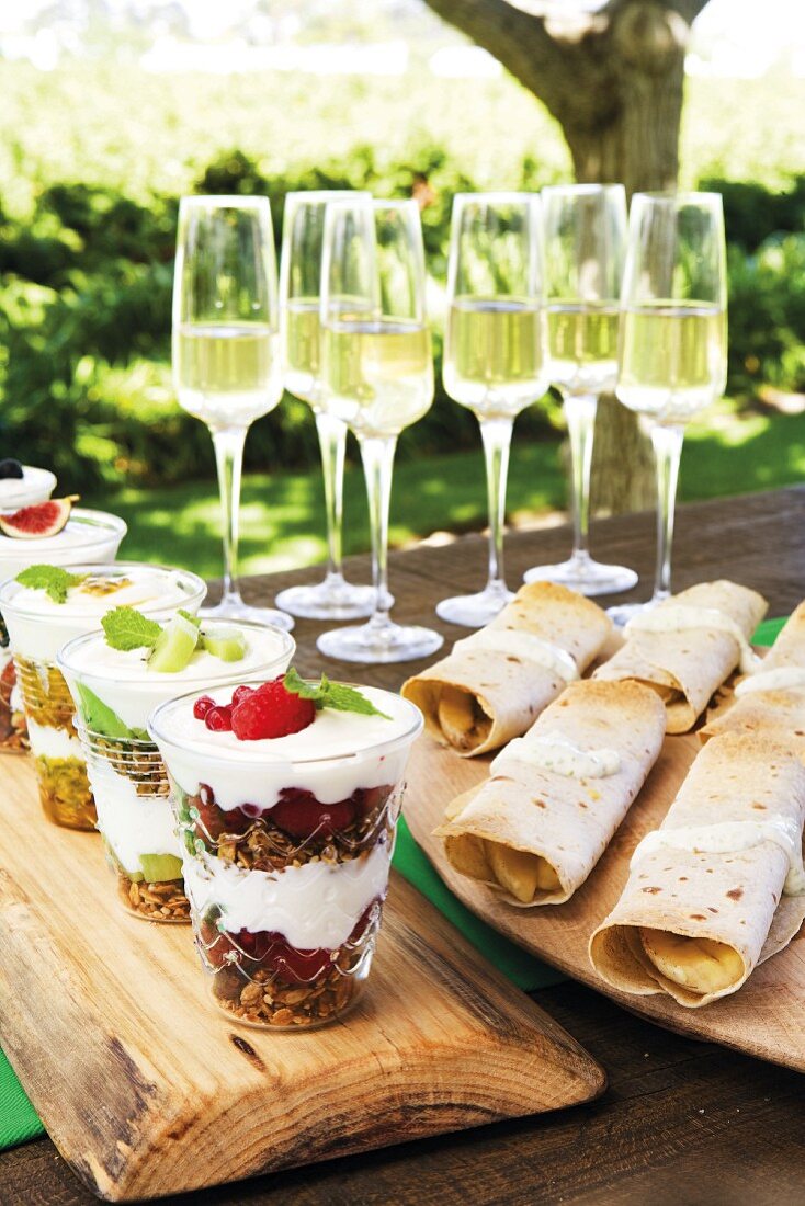 Brunch outdoors with sparkling wine, crispy muesli and sweet wraps