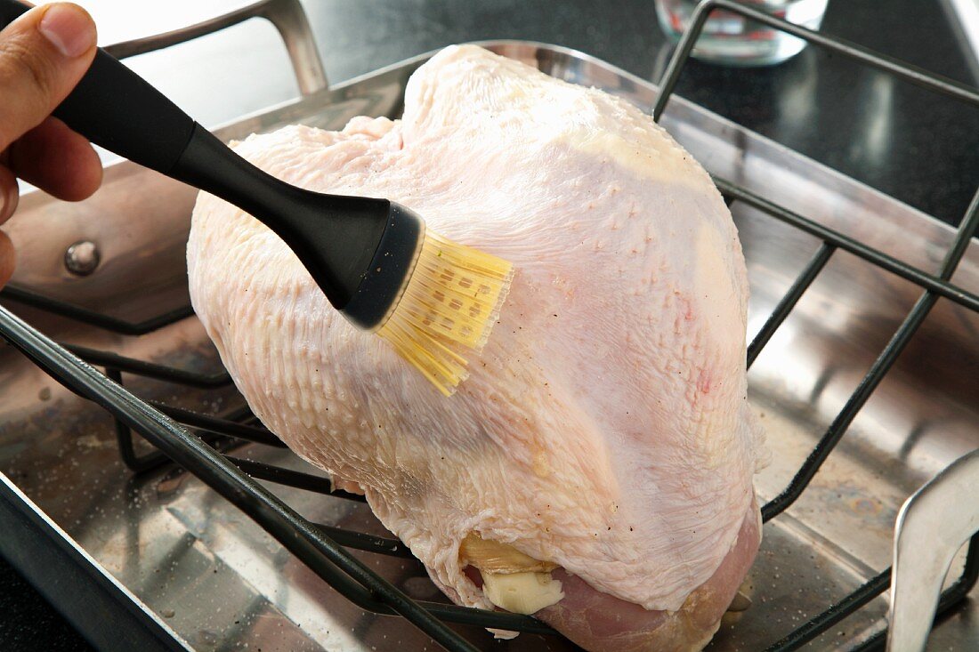 Brushing Butter on a Turkey Breast in the Oven for Roasting